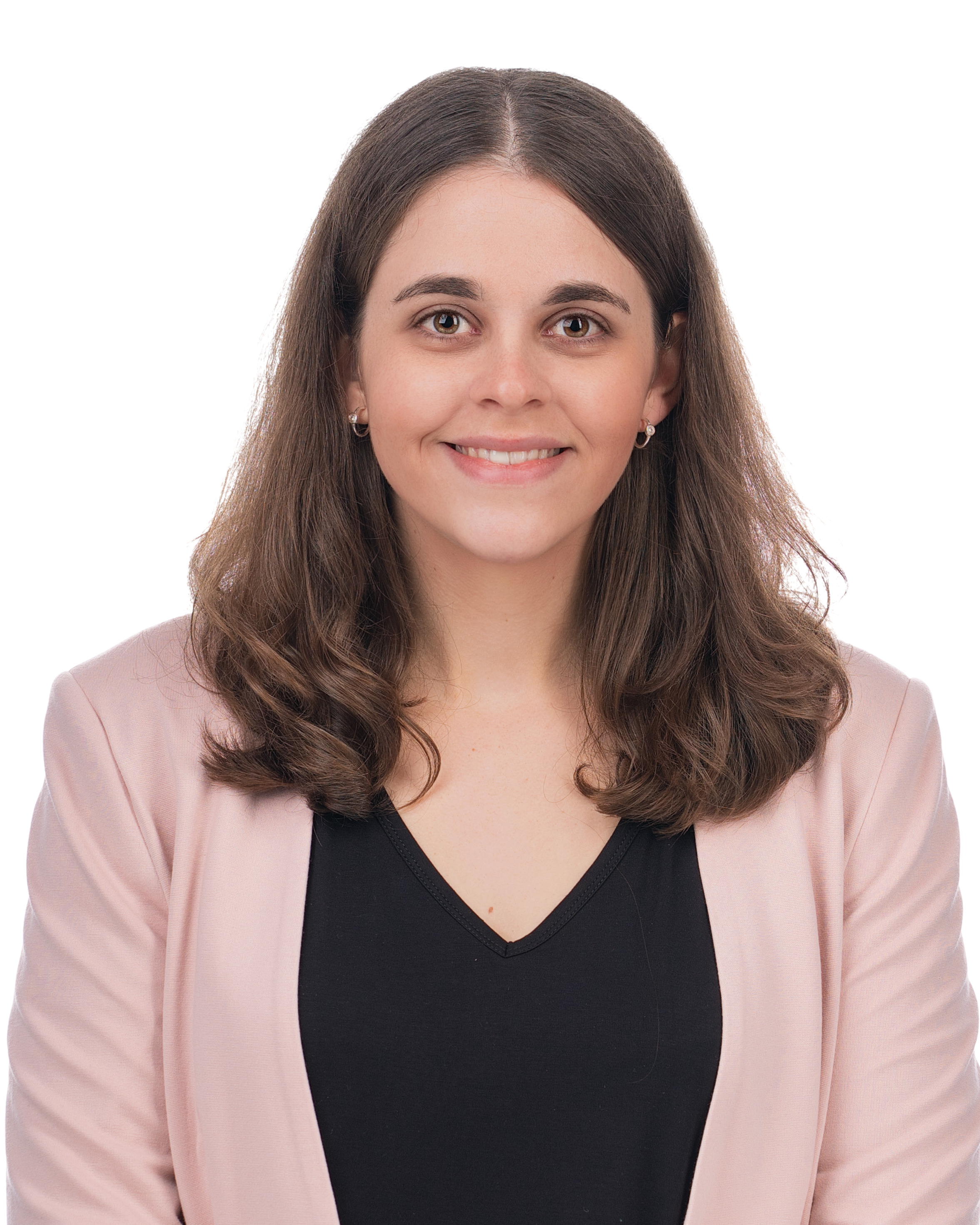 A person with brown hair wearing a pink jacketDescription automatically generated